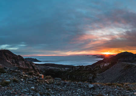 landscape of mountains at sunrise above the cloudsの写真素材