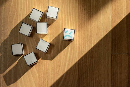 Top view of blank paper boxes, with a sad and displaced face.の写真素材
