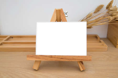 blank frame easel on wooden tableの写真素材