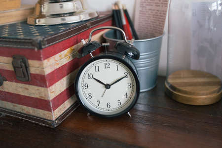 clock and decer on wooden table