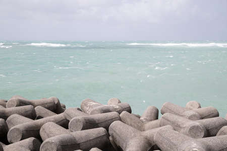 tropical sea with waves and breakwaterの写真素材