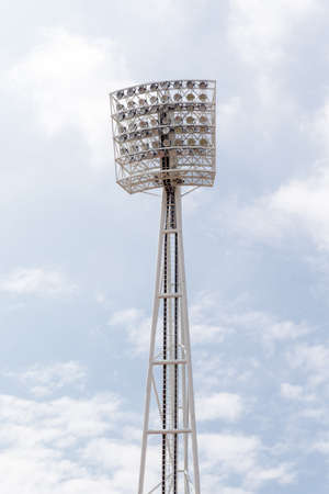 Large tall high outdoor stadium spotlights on rigid frame construction under natural sunlightの写真素材