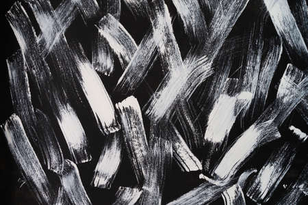 abstract painted by white brush on black background texture.