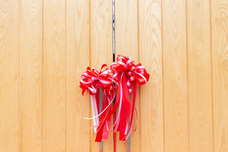 close up of wooden gate with red ribbon.の写真素材
