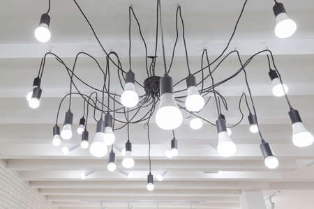 hanging light bulb with wire from ceiling.