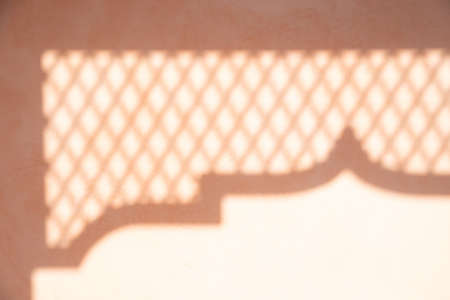 abstract shadow background of pole and steel grille on pastel tone wall.の写真素材