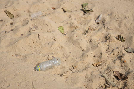 plastic bottles garbage waste on sand causing environment pollution.の写真素材