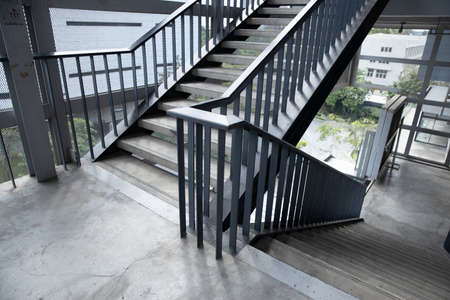Empty concrete staircase with black iron handrail.の写真素材