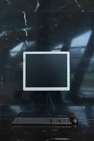 desktop computer on black marble wall and table.の写真素材