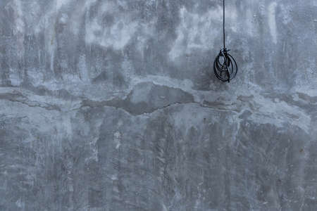 roll up of black electric wires with cement wall background.の写真素材