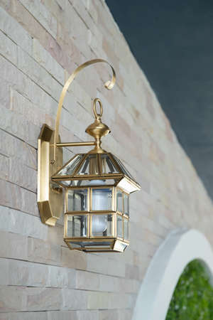 exterior wall golden lantern on the tile wall.