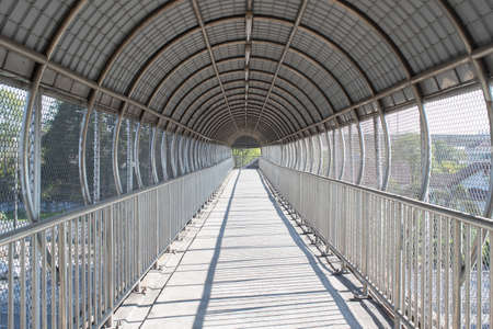empty overpass with roof and protection mesh metal fence.の写真素材