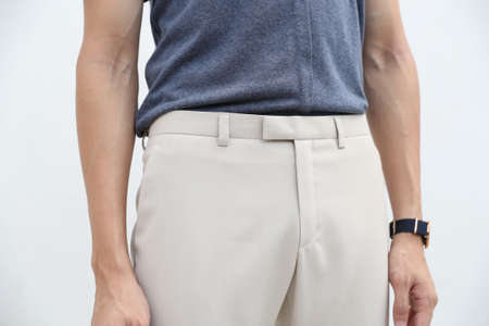 close-up of handsome man in blue shirt and white long trousers.の写真素材