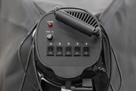 back view of black spotlight or continuous light with on-off switch, fuse and wire.
