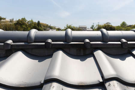 closeup of traditional tiles rooftop at historic Japan house with Japanese style.