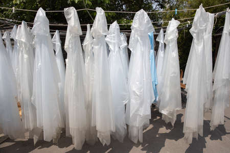group of many hanging plastic raincoat or waterproof hood jacket for tourist in rainy day during...