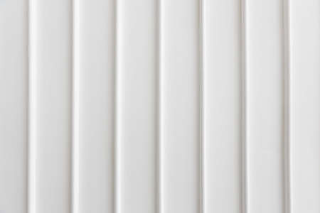 close up of simplicity white wall with vertical line pattern panel background texture.