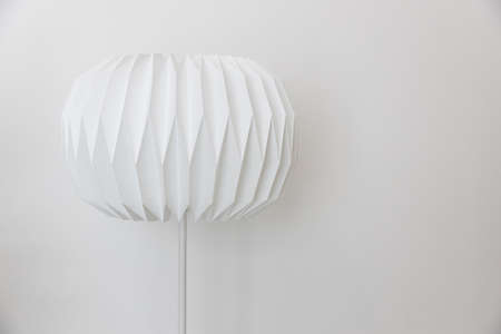 single unique round shape paper electric floor lamp on white wall background.の写真素材
