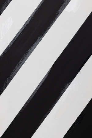 close up of wooden plank painted by herringbone black and white color.