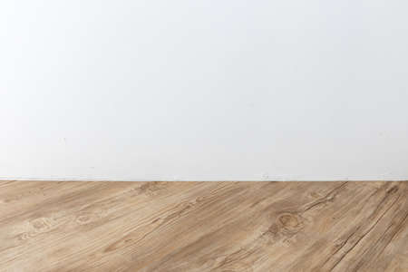 perspective view of empty interior room with white cement wall and brown wooden herringbone plank...