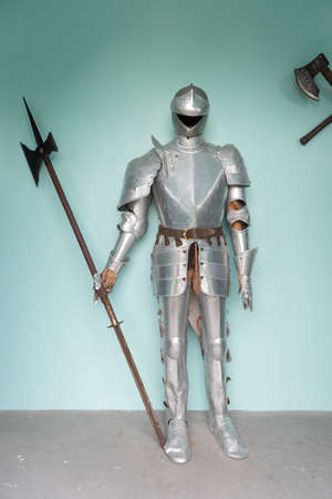 A standing vintage steel full body armor suit with spear.の写真素材
