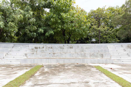 exterior view of empty outdoor long stone seat or chair stand in sport stadium zone.の写真素材