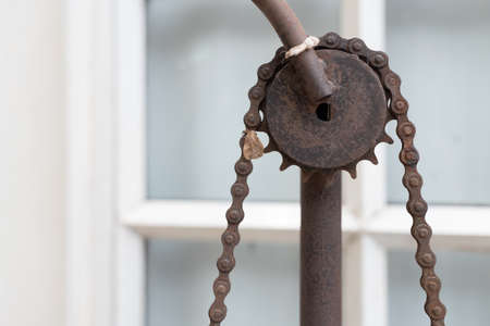 close up view of abandoned rusty gear and chain as house decoration