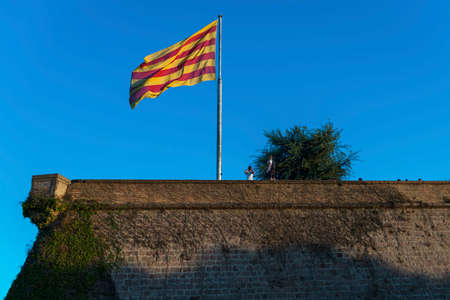 Senyera flag at Montjuic Castle in Barcelona signifies Catalonian desire to independence from Spain.の写真素材