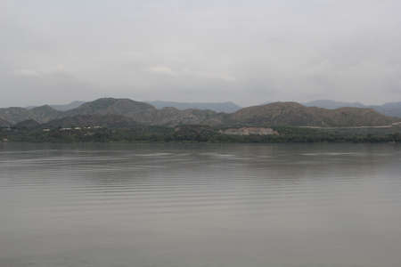 View of the lake and the mountains in the background. Shot in West Bengal, India.の写真素材