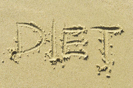 "Diet" - handwritten in sand beachの写真素材