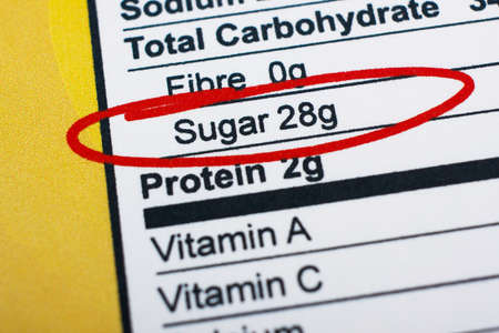 Photo of a nutrition facts label. High amount sugar in foodの写真素材