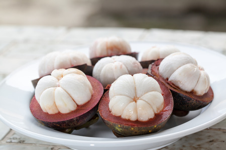tropical mangosteen fruit on wood tableの写真素材