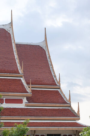 Thai art on roof Church at Thai temple. with skyの写真素材