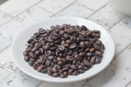 pour coffee grounds into the plant on mableの写真素材