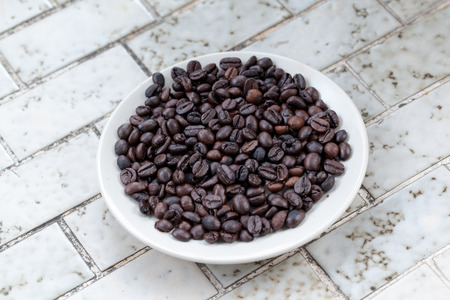 pour coffee grounds into the plant on mableの写真素材