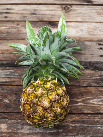 Fresh whole pineapple on wood tableの写真素材