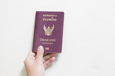women Hand holding passport - white wallの写真素材