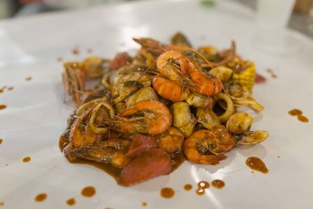 fresh shrimps served on a wood plate with garlic onion and chili