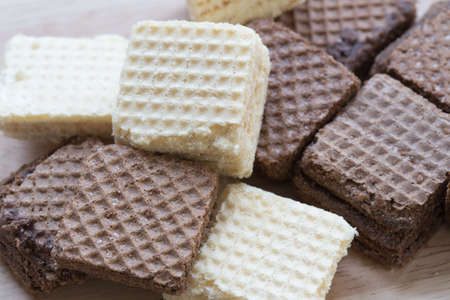 Wafers or honeycomb chocolat and Milk waffles isolated on wood backgroundの写真素材