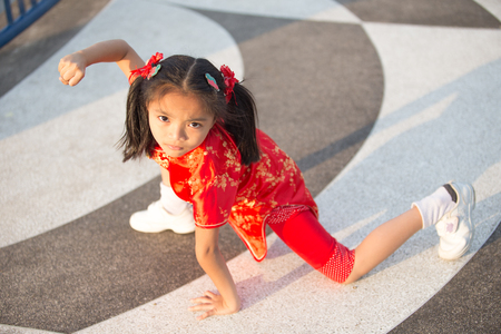 Beautiful Asian kids girl with Chinese traditional dress Cheongsam ( Learn chinese martial art )の写真素材