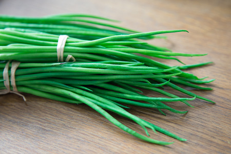 Green onion on wood backgroundの写真素材