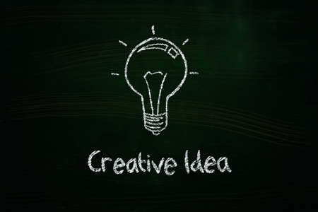 creative idea lightbulb illustration sketched with chalk on blackboardの写真素材