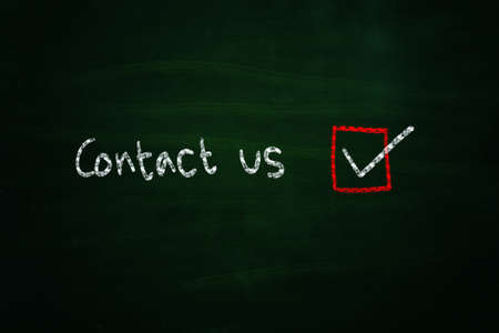 contact us illustration sketched with chalk on blackboardの写真素材