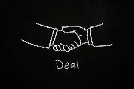 deal handshake illustration sketched with chalk on blackboardの写真素材