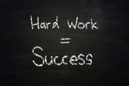 hard work equal success chalk written on blackboardの写真素材