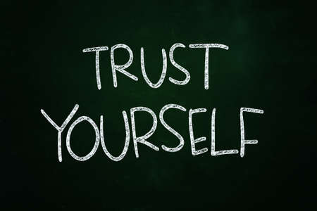 Trust Yourself Lettering, Motivational Phrase written with Chalk on Blackboardの写真素材