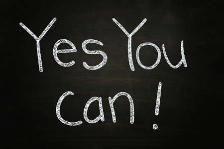 Yes You Can, Motivational Phrase written with Chalk on Blackboardの写真素材