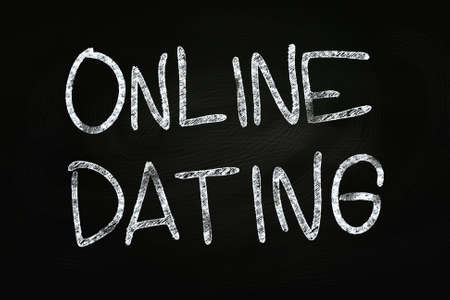 Online Dating writing, written with Chalk on Blackboardの写真素材