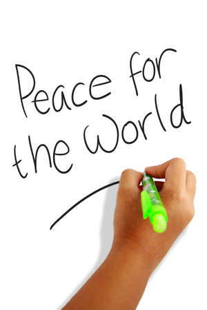 Girls hand holding a pen writing Peace for the Worldの写真素材