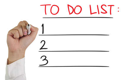 Business concept image of a hand holding marker and write To Do List isolated on whiteの写真素材